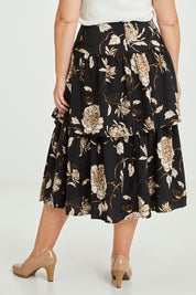Model Fiona wearing size 16 of the Samara Skirt in colour Disbud (Black), from the back