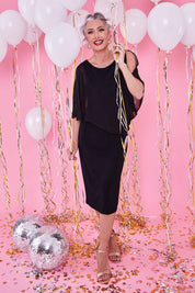 Model Luisa wearing size 10 of the Cassandra Dress in colour Black (Black), from the front, showing the whole outfit