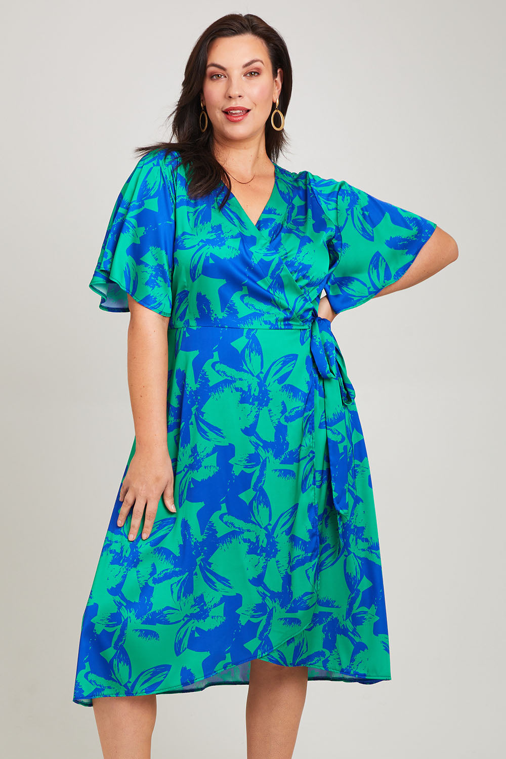 Model Poppy wearing size 16 of the Alanah Wrap Dress in colour Bahamas (Green), from the front, cropped image