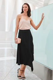 Model Anneliese wearing size 10 of the Yen Skirt in colour Black (Black), from the front, showing the whole outfit