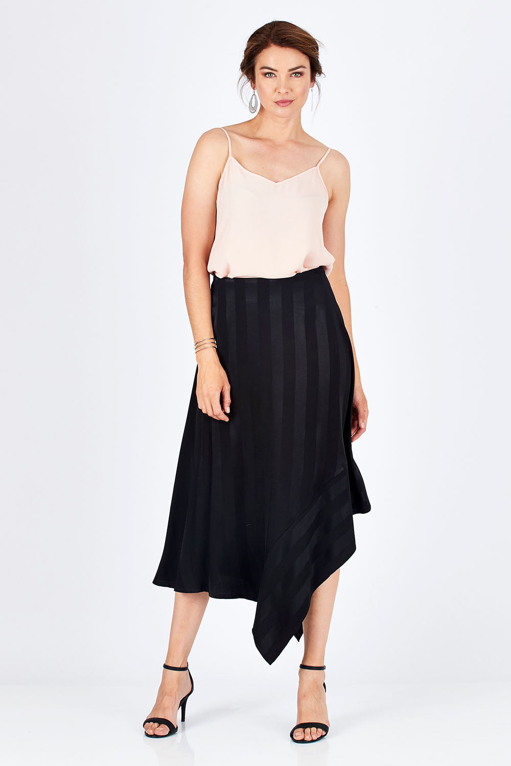 Model Rebecca wearing size 10 of the Yen Skirt in colour Black (Black), from the front, showing the whole outfit