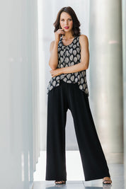 Model Andrea wearing size 10 of the Olivia Jumpsuit in colour Leaf (Black), from the front, showing the whole outfit