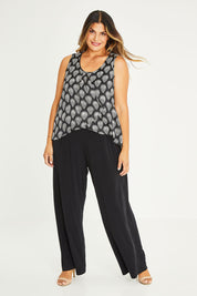 Model Palatina wearing size 16 of the Olivia Jumpsuit in colour Leaf (Black), from the front, showing the whole outfit