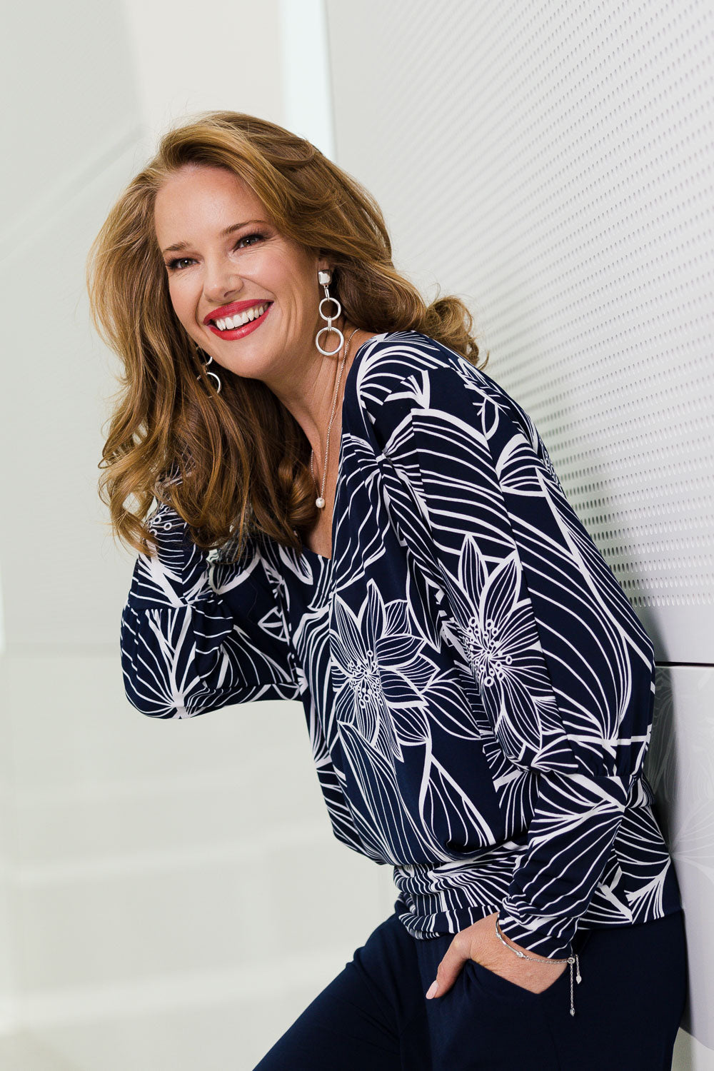 Model Katie wearing size 10 of The Printed Kelly Blouse in colour Navyleaves (Blue), from the front, showing the whole outfit