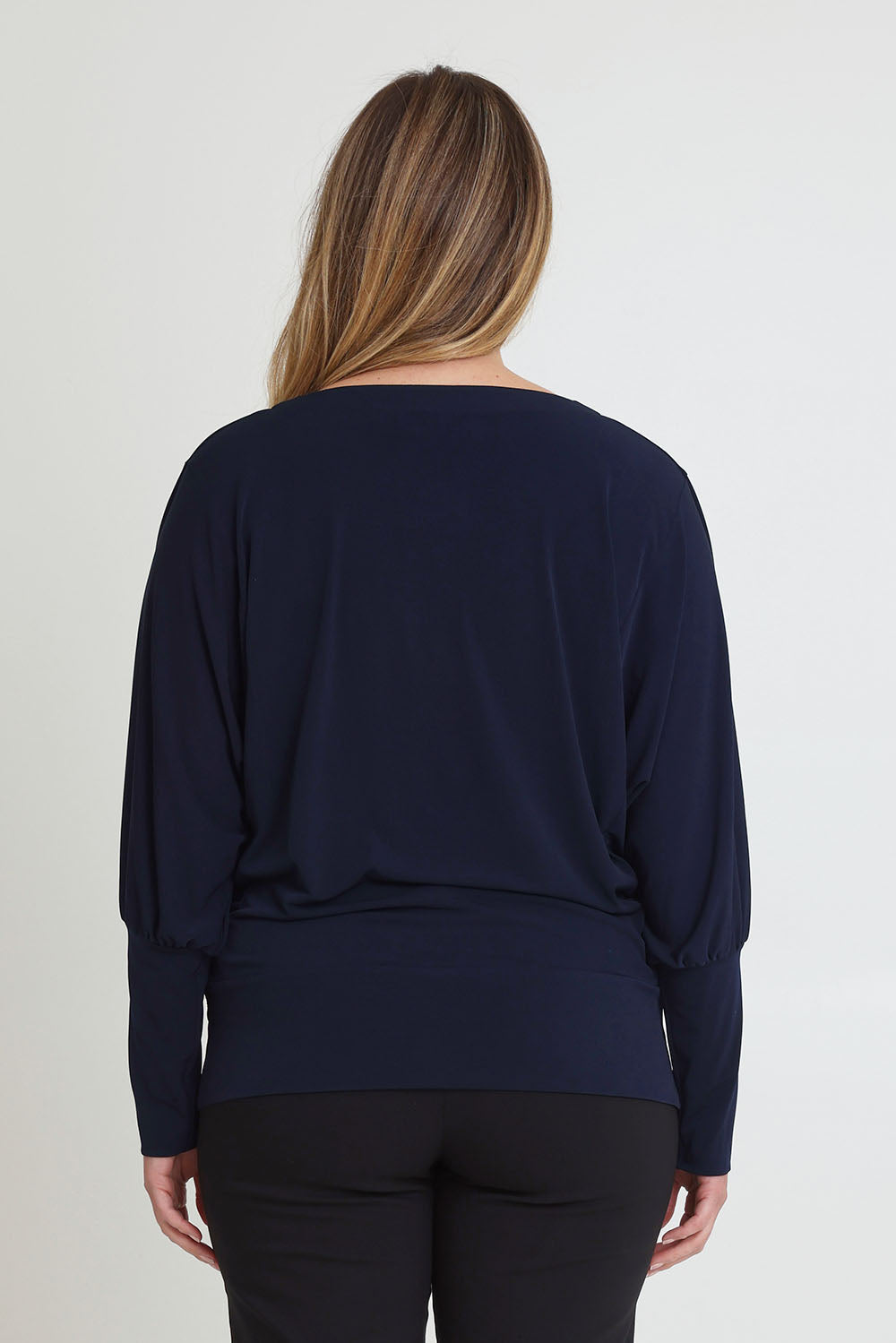 Model Chanel wearing size 16 of the Kelly Blouse in colour Navy (Blue), from the back