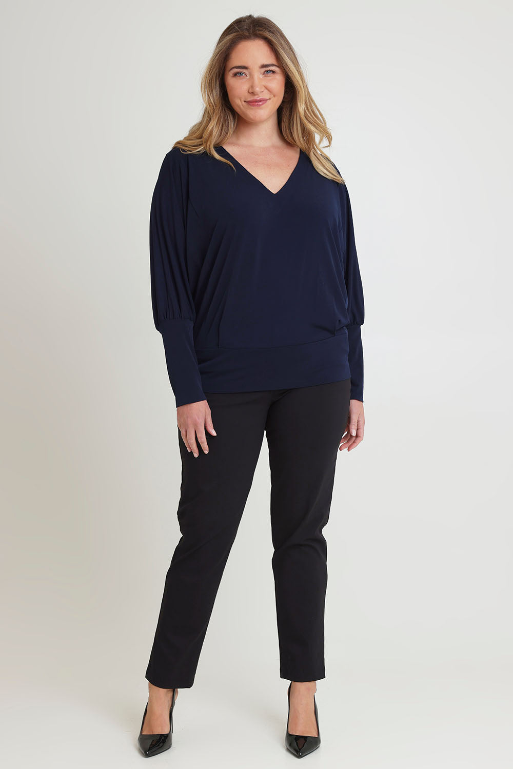 Model Chanel wearing size 16 of the Kelly Blouse in colour Navy (Blue), from the front, showing the whole outfit
