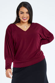 Model Sasha-Lee wearing size 16 of the Kelly Blouse in colour Port (Red), from the front, cropped image