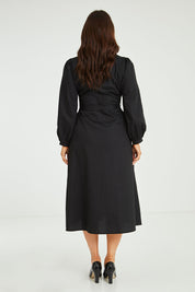 Model Laura wearing size 14 of the Jane Shirt Dress in colour Black (Black), from the back