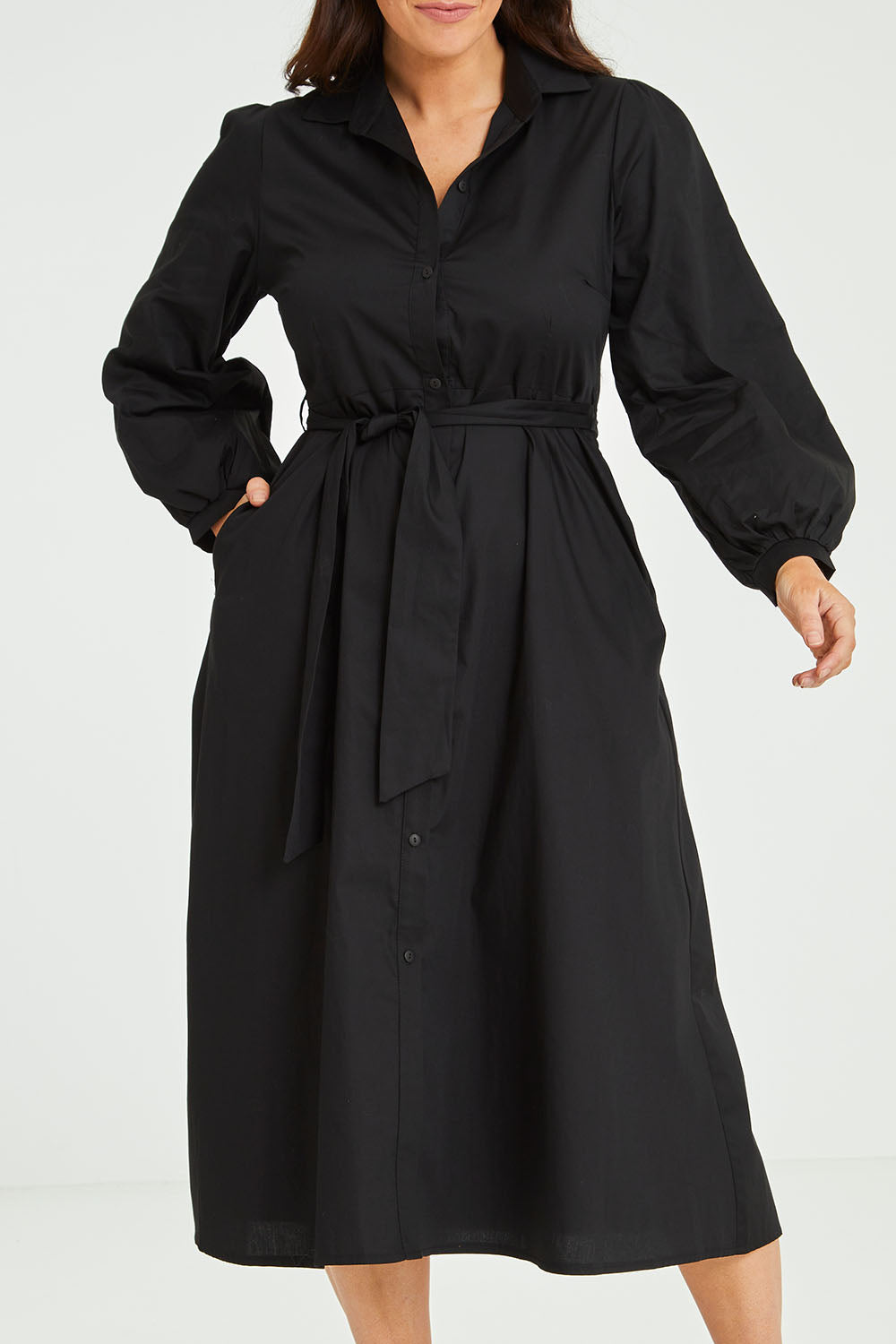 Model Laura wearing size 14 of the Jane Shirt Dress in colour Black (Black), from the front, cropped image