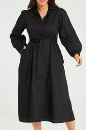 Model Laura wearing size 14 of the Jane Shirt Dress in colour Black (Black), from the front, cropped image