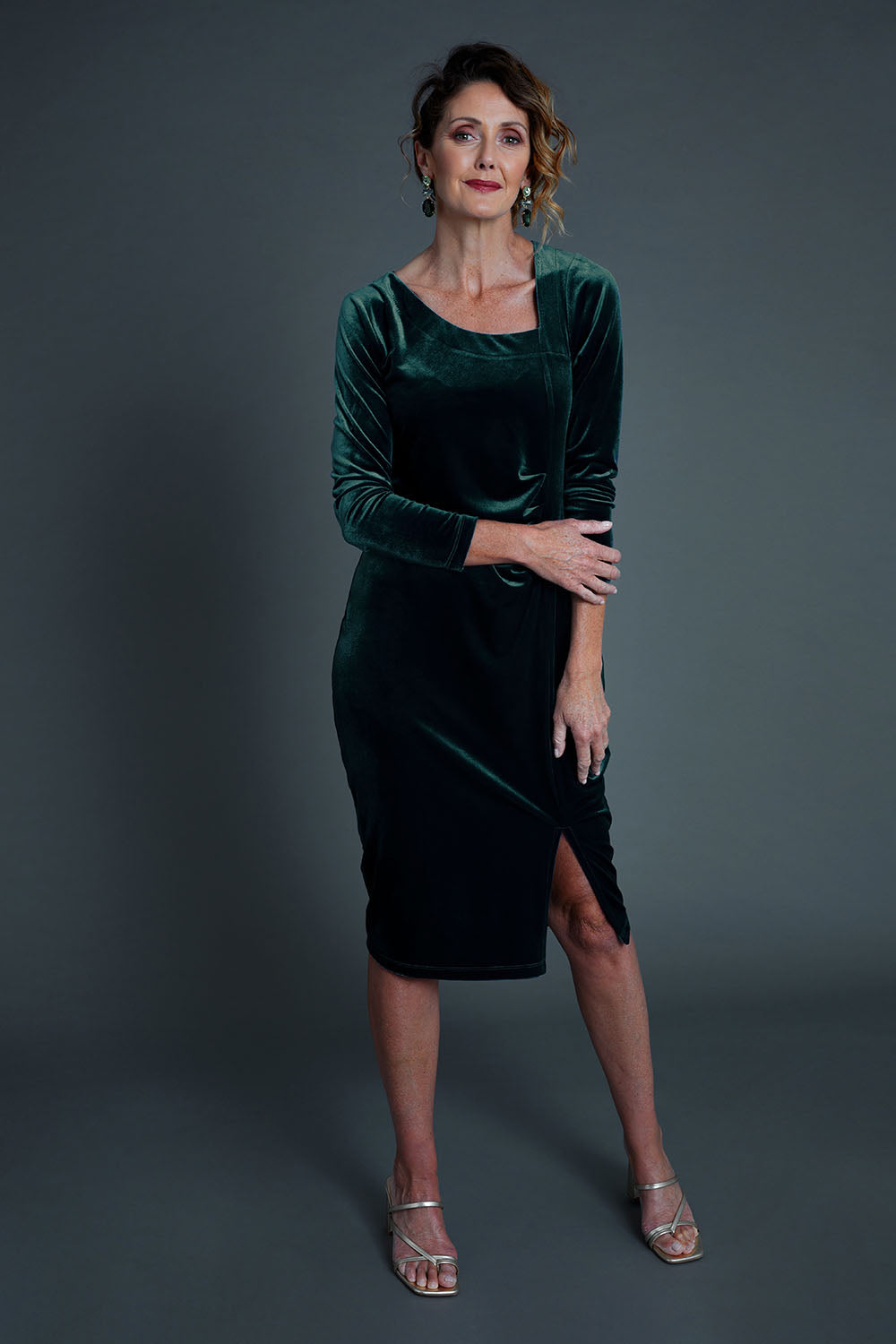 Model Emma wearing size 10 of the Diana Velvet Dress in colour Ivy (Green), from the front, showing the whole outfit