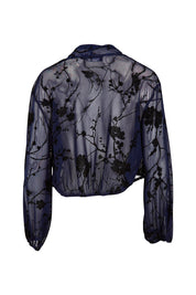 Product shot of the Penny Shrug in colour Navyfleur (Blue), from the back