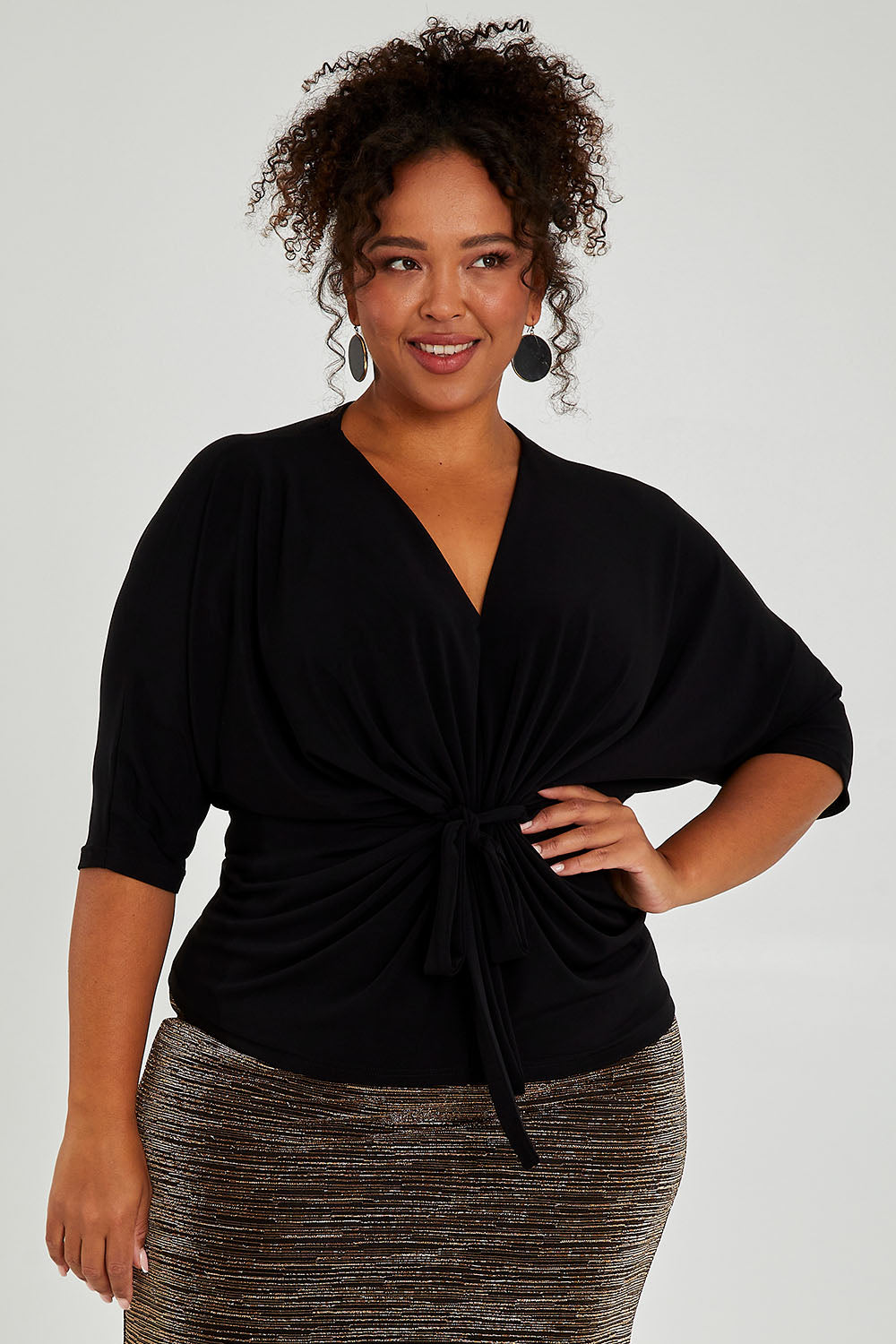 Model Alexis wearing size 16 of the Niamh Top in colour Black (Black), from the front, cropped image