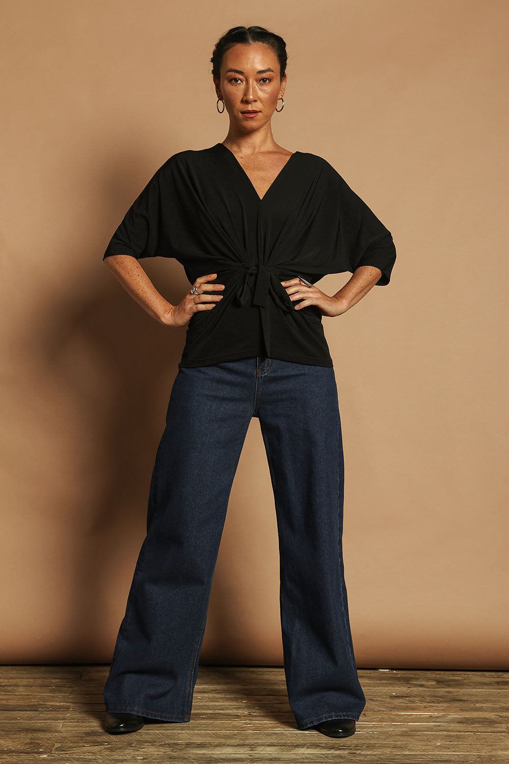 Model Katie wearing size 10 of the Niamh Top in colour Black (Black), from the front, showing the whole outfit
