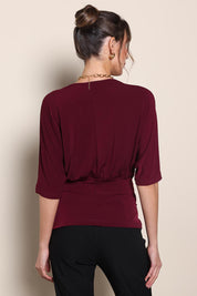 Model Maddiec wearing size 10 of the Niamh Top – Port in colour Port, from the back