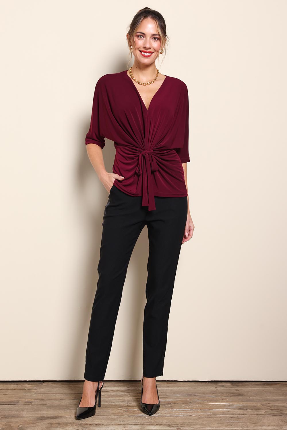 Model Maddiec wearing size 10 of the Niamh Top – Port in colour Port, from the front