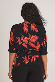 Model Terri-Leigh wearing size 14 of The Printed Niamh Top in colour Firelight (Black), from the back