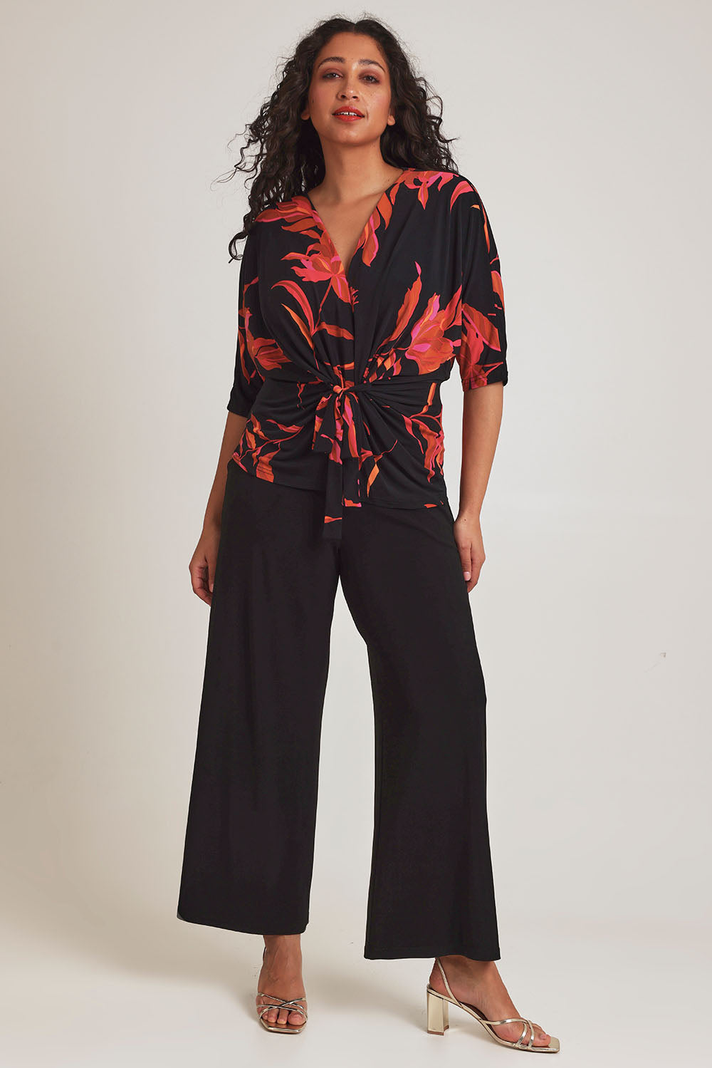 Model Terri-Leigh wearing size 14 of The Printed Niamh Top in colour Firelight (Black), from the front, showing the whole outfit
