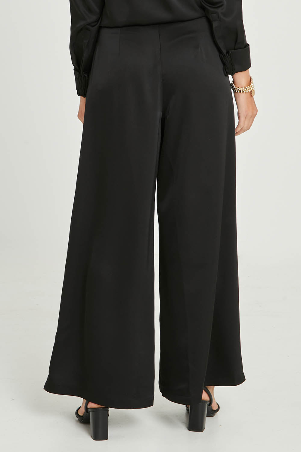 Model Madeline wearing size 10 of the Mandy Pants in colour Black (Black), from the back