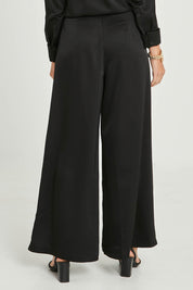 Model Madeline wearing size 10 of the Mandy Pants in colour Black (Black), from the back