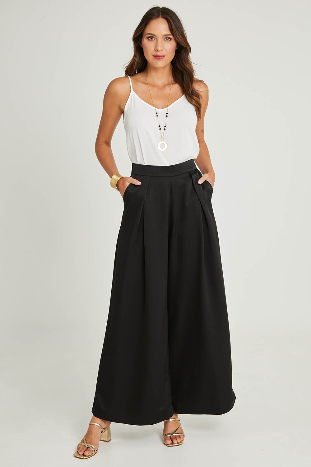Model Madeline wearing size 10 of the Mandy Pants in colour Black (Black), from the front, showing the whole outfit