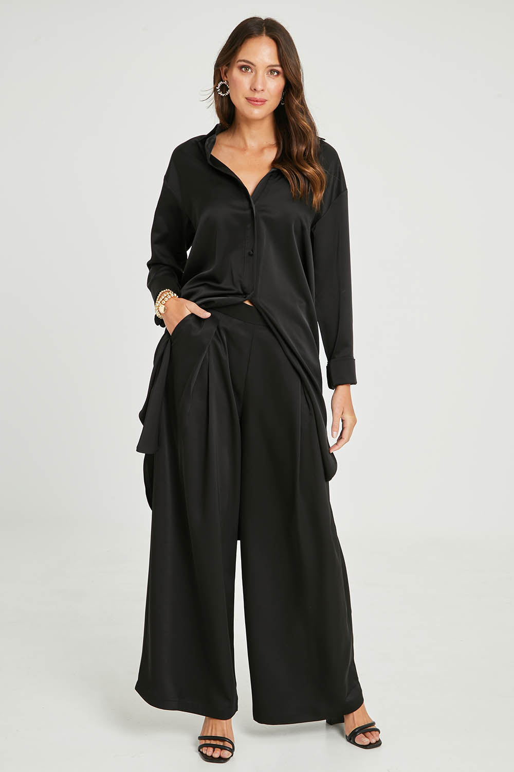 Model Madeline wearing size 10 of the Mandy Pants in colour Black (Black), from the front, showing the whole outfit