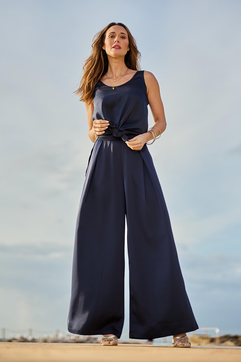 Model Clementine wearing size 10 of the Mandy Pants in colour Navy (Blue), from the front, showing the whole outfit