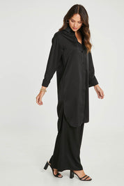 Model Madeline wearing size 10 of the Mandy Shirt in colour Black (Black), from the front, showing the whole outfit