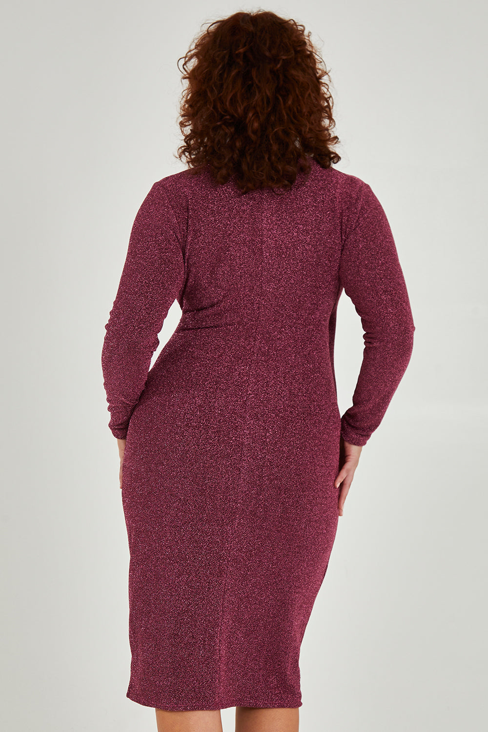 Model Maddy wearing size 16 of the Charleen Dress in colour Berry (Pink), from the back