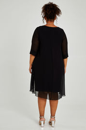 Model Alexis wearing size 16 of the Bethany Dress in colour Black (Black), from the back
