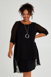 Model Alexis wearing size 16 of the Bethany Dress in colour Black (Black), from the front, cropped image