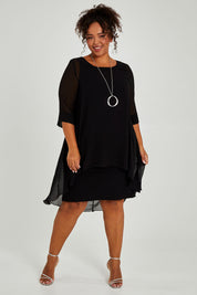 Model Alexis wearing size 16 of the Bethany Dress in colour Black (Black), from the front, showing the whole outfit