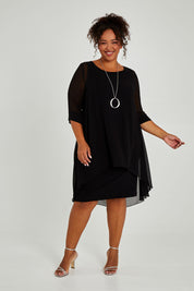 Model Alexis wearing size 16 of the Bethany Dress in colour Black (Black), from the front, showing the whole outfit