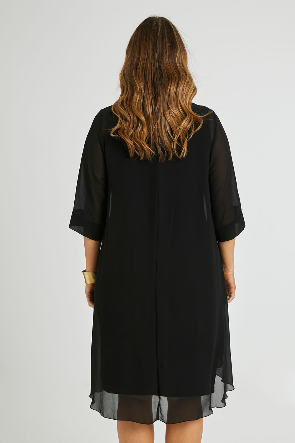Model Laura wearing size 14 of the Bethany Dress in colour Black (Black), from the back