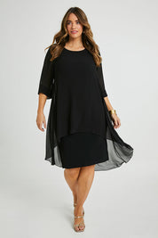 Model Laura wearing size 14 of the Bethany Dress in colour Black (Black), from the front, showing the whole outfit
