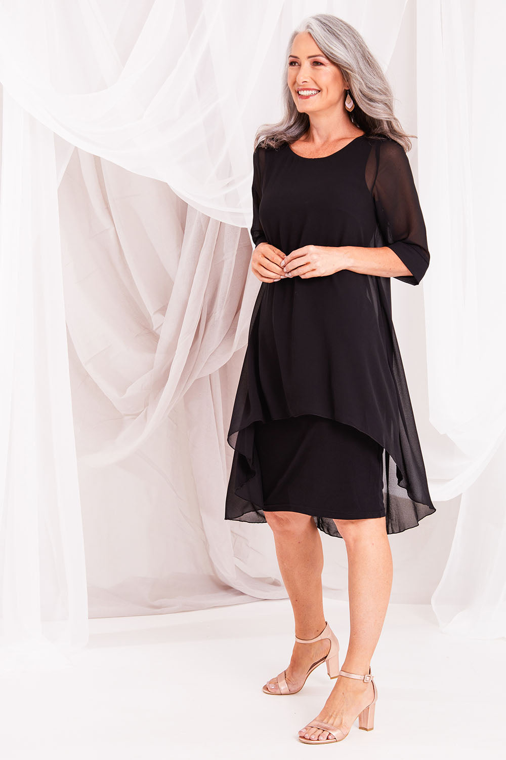 Model Luisa wearing size 10 of the Bethany Dress in colour Black (Black), from the front, showing the whole outfit