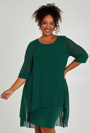 Model Alexis wearing size 16 of the Bethany Dress in colour Pine (Green), from the front, cropped image