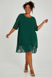 Model Alexis wearing size 16 of the Bethany Dress in colour Pine (Green), from the front, showing the whole outfit