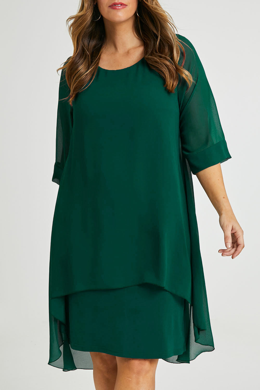Model Laura wearing size 14 of the Bethany Dress in colour Pine (Green), from the front, cropped image