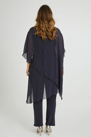 Model Laura wearing size 14 of the Sandy Jumpsuit in colour Charcoal (Grey), from the back