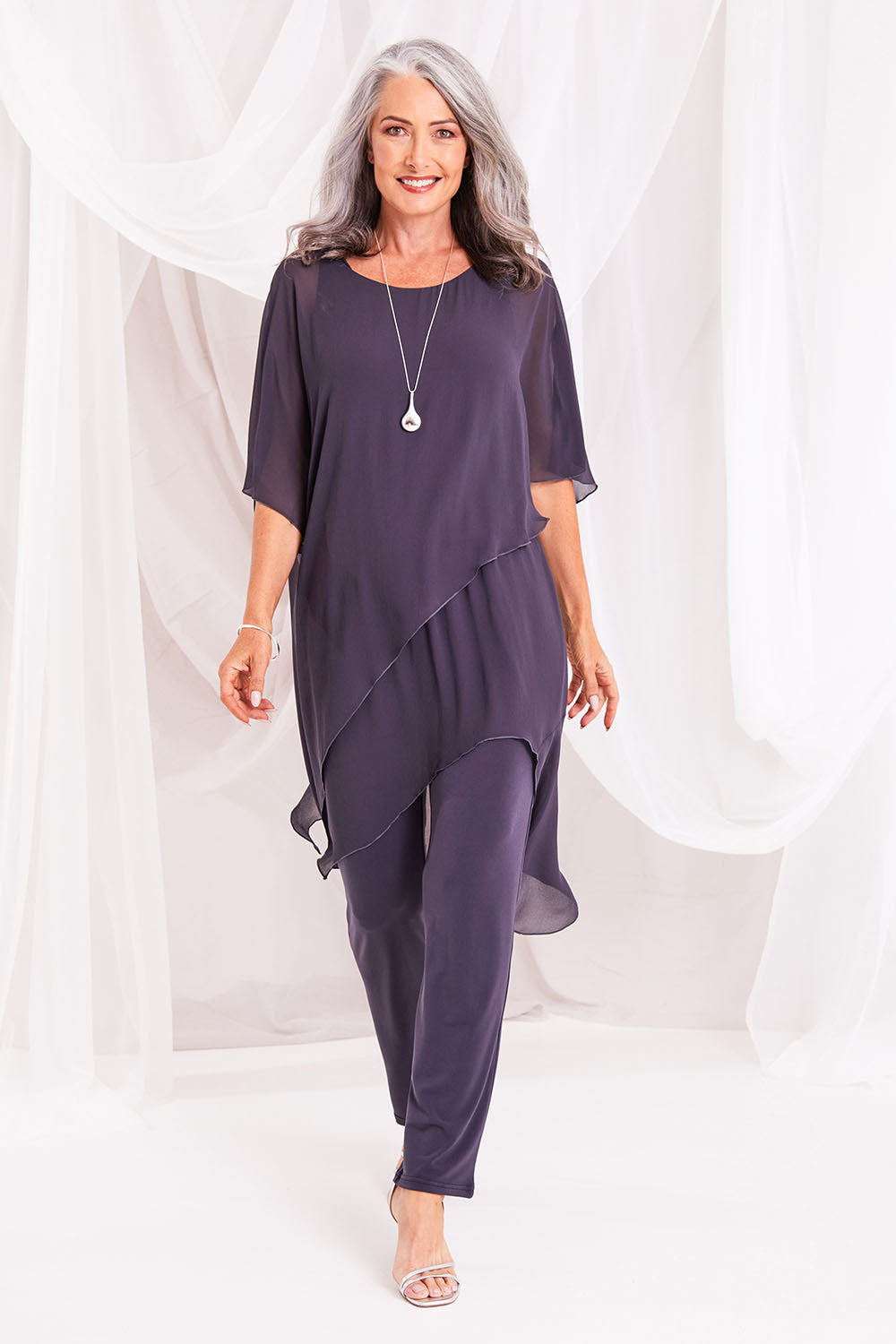Model Luisa wearing size 10 of the Sandy Jumpsuit in colour Charcoal (Grey), from the front, showing the whole outfit