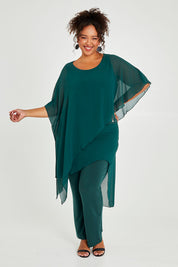 Model Alexis wearing size 18 of the Sandy Jumpsuit in colour Pine (Green), from the front, showing the whole outfit