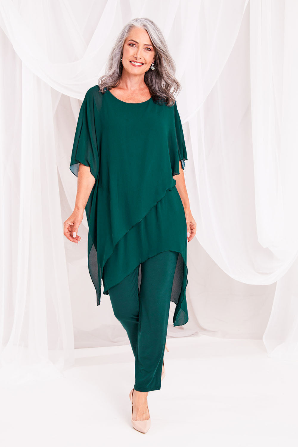 Model Luisa wearing size 10 of the Sandy Jumpsuit in colour Pine (Green), from the front, showing the whole outfit