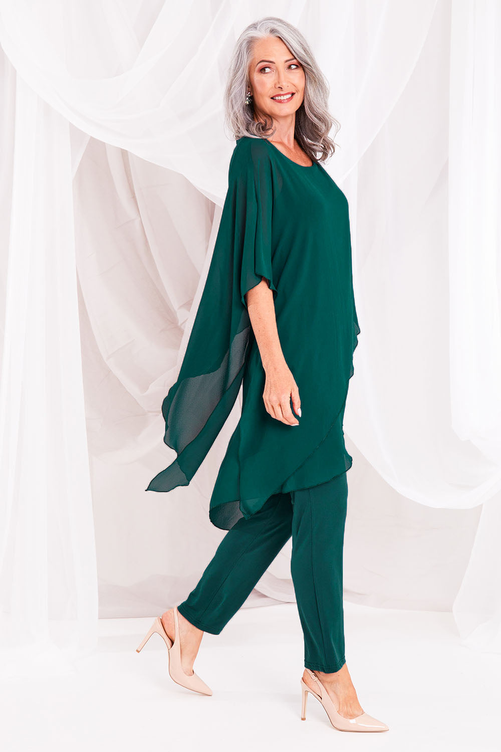 Model Luisa wearing size 10 of the Sandy Jumpsuit in colour Pine (Green), from the front, showing the whole outfit