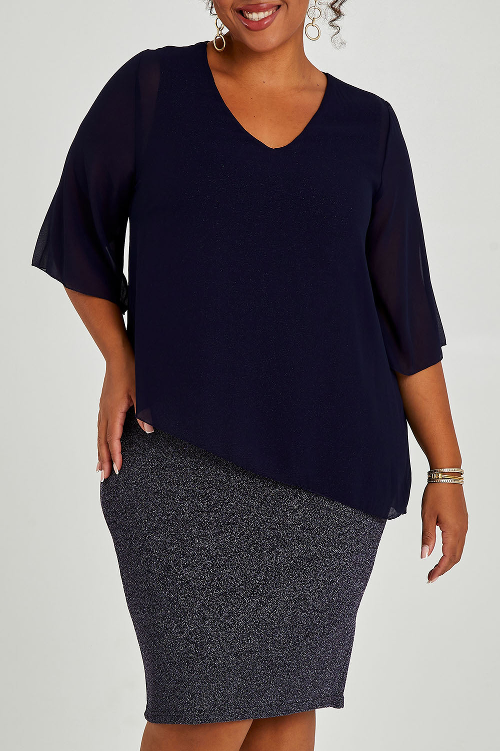 Model Alexis wearing size 16 of the Bridgette Dress in colour Navy (Blue), from the front, cropped image