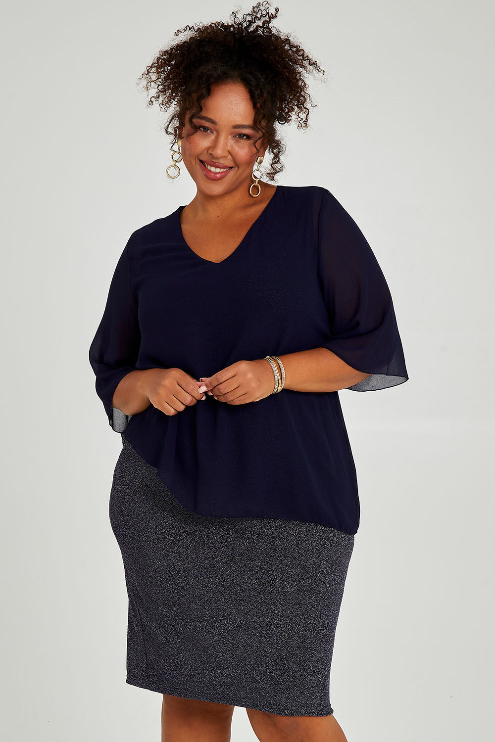 Model Alexis wearing size 16 of the Bridgette Dress in colour Navy (Blue), from the front, cropped image