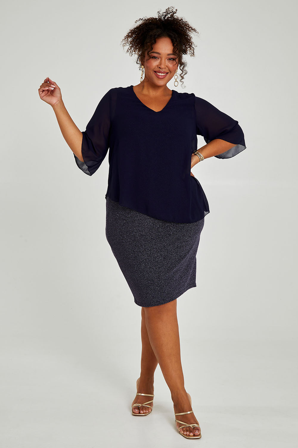 Model Alexis wearing size 16 of the Bridgette Dress in colour Navy (Blue), from the front, showing the whole outfit