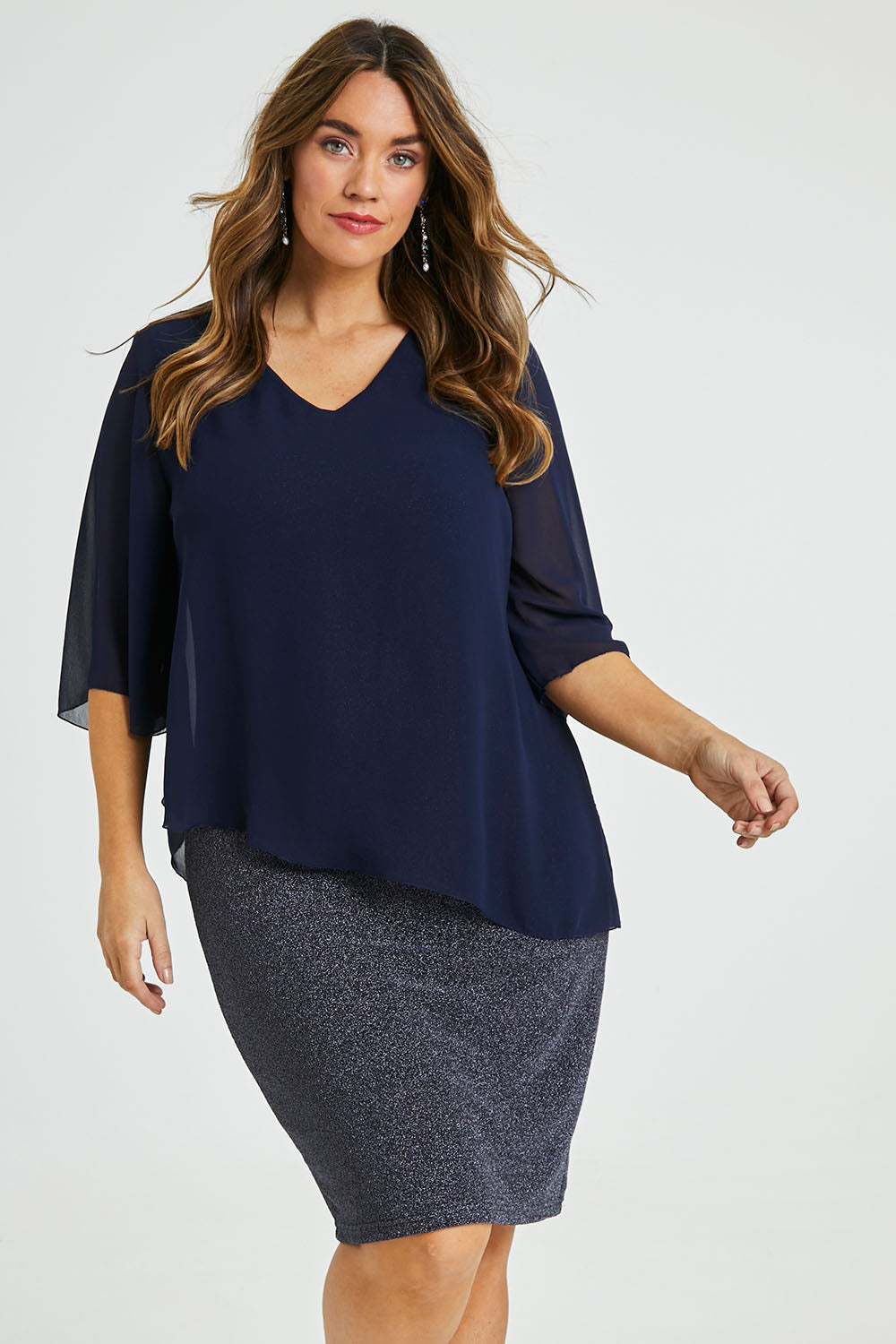 Model Laura wearing size 14 of the Bridgette Dress in colour Navy (Blue), from the front, cropped image