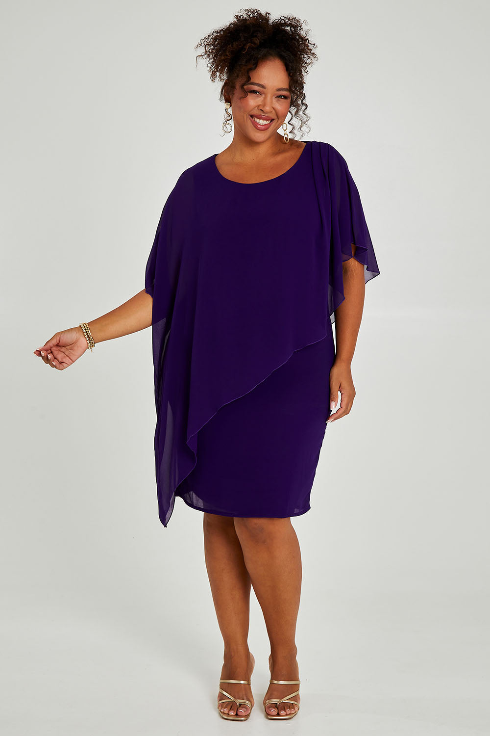 Model Alexis wearing size 16 of the Beatrice Dress in colour Purple (Purple), from the front, showing the whole outfit