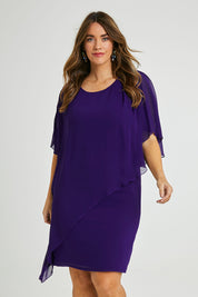 Model Laura wearing size 14 of the Beatrice Dress in colour Purple (Purple), from the front, cropped image